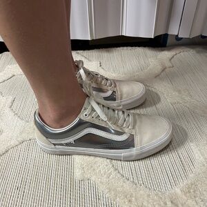 Silver and white Vans tennis shoes